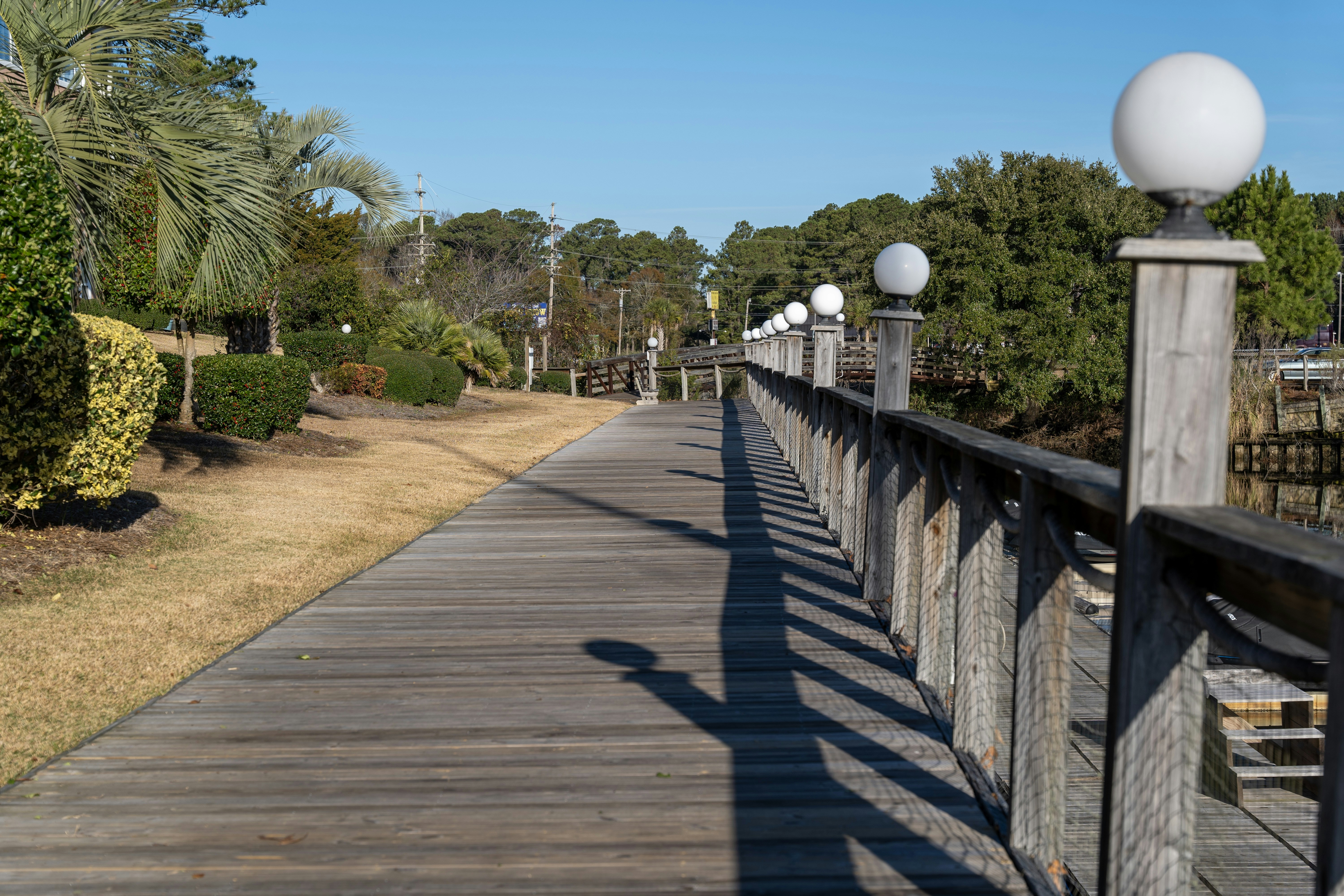 a wooden walkway with a white light on top of it, 