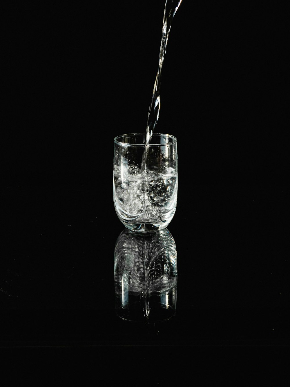 a glass filled with water sitting on top of a table