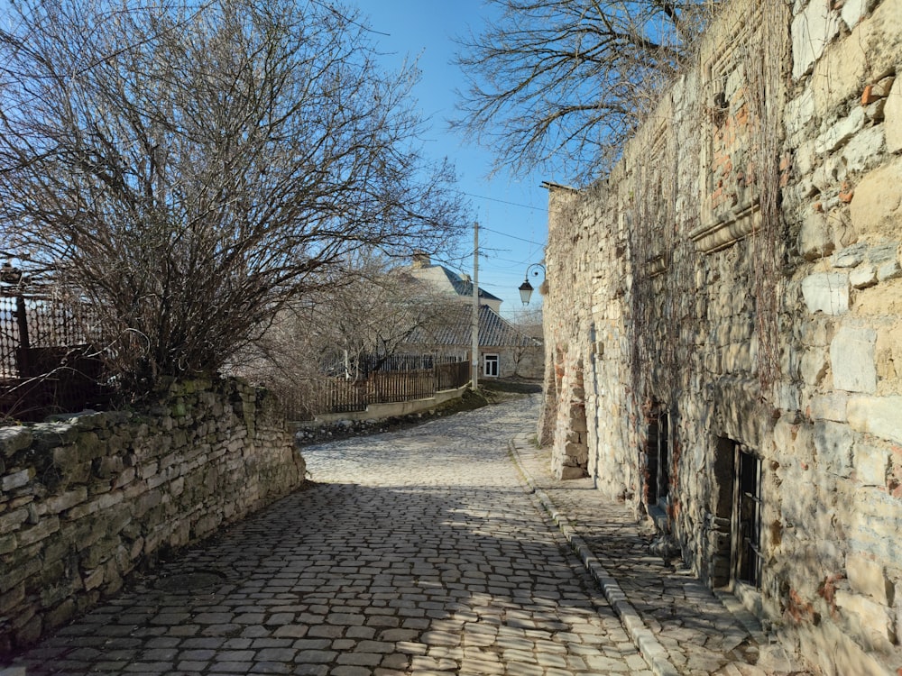 a cobblestone street lined with stone buildings