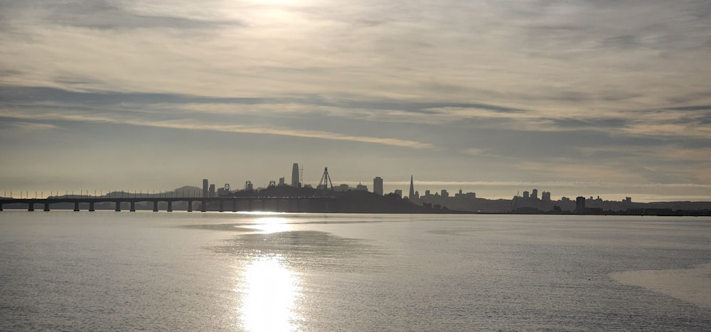 a large body of water with a city in the background