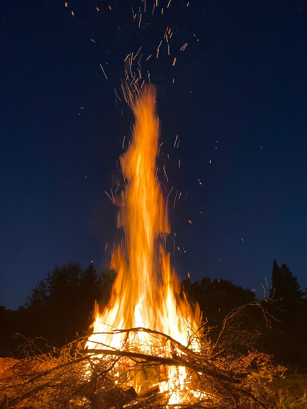 a fire is lit in a field at night