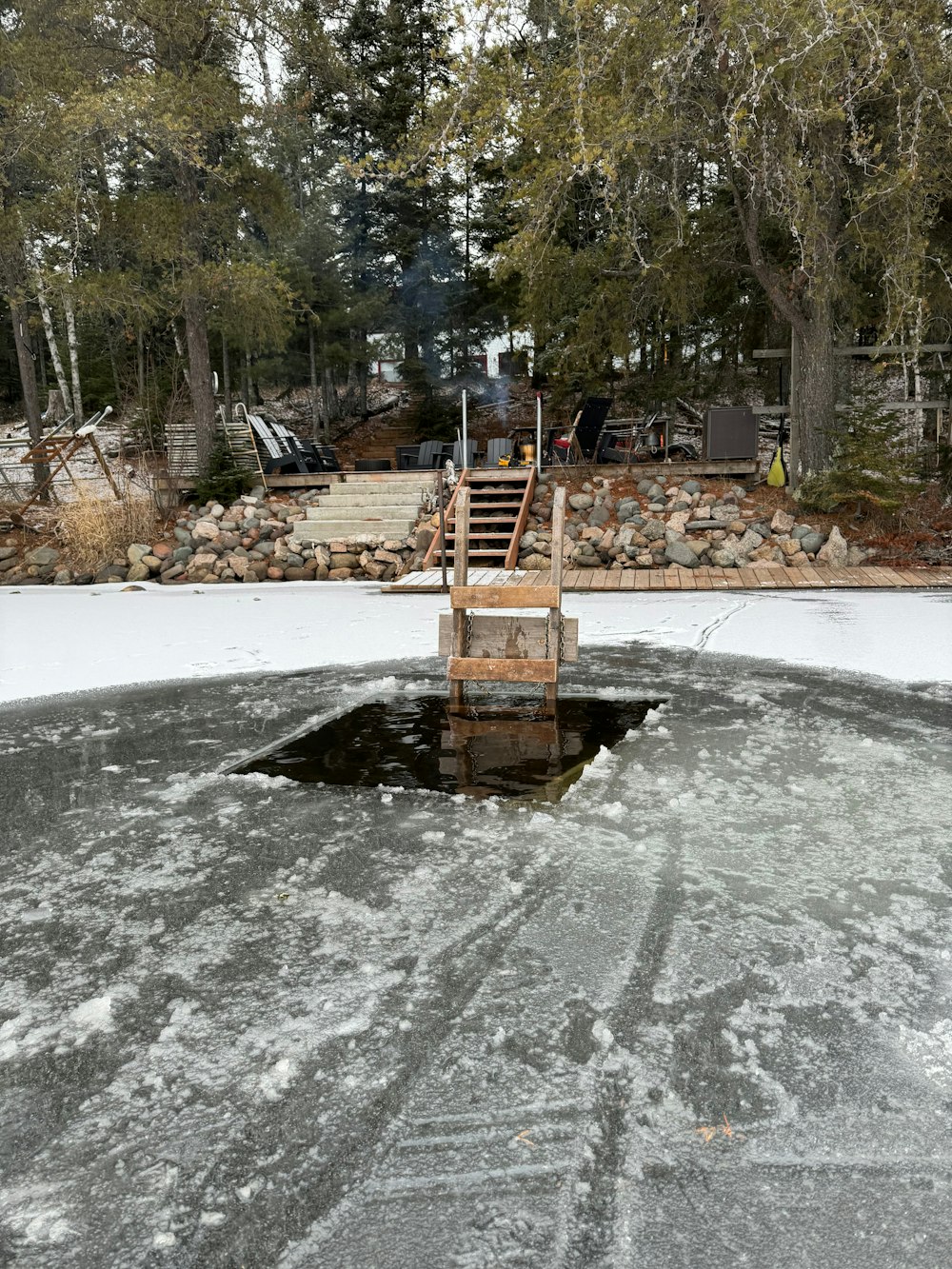 a wooden dock sitting on top of a frozen lake