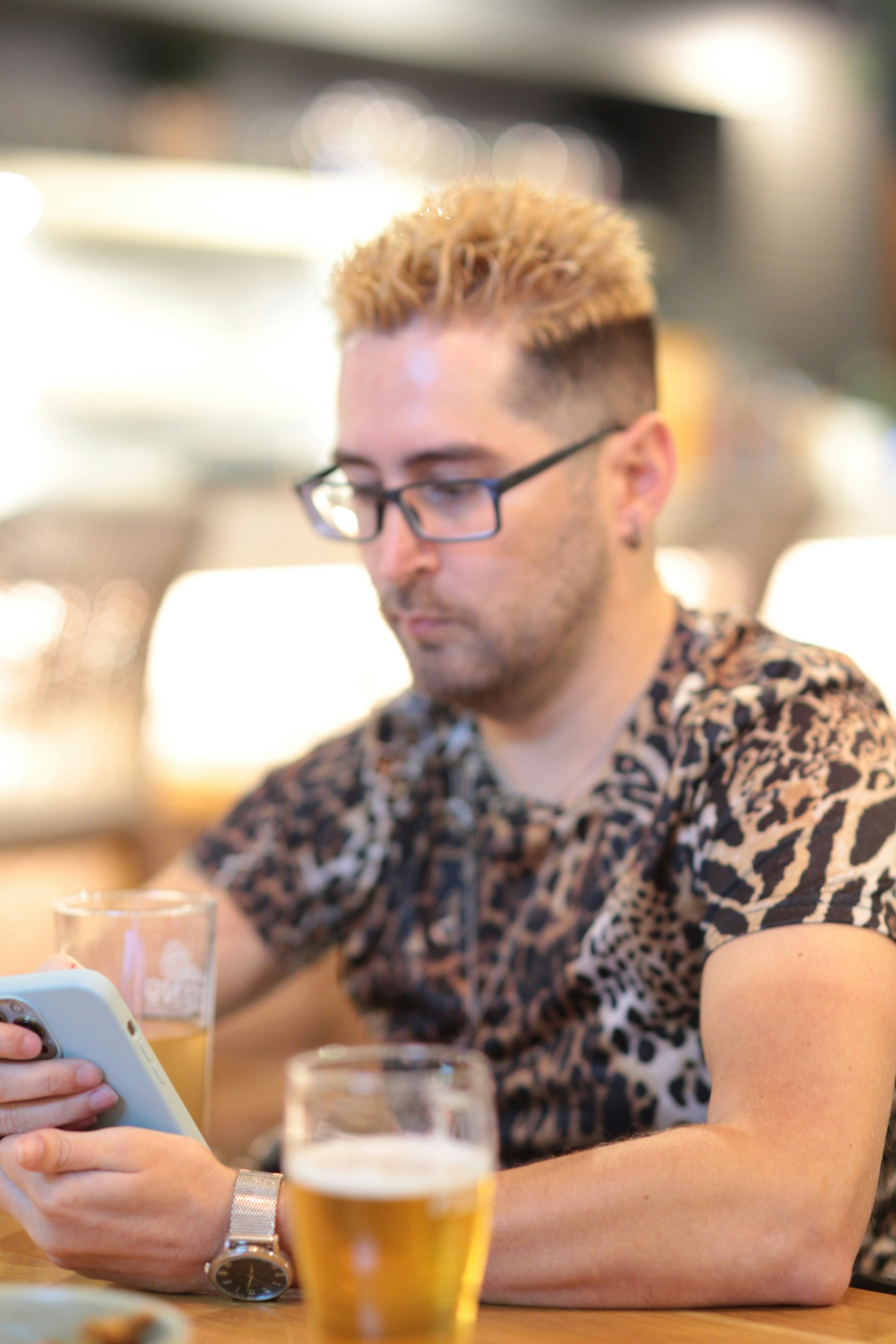a man sitting at a table with a tablet