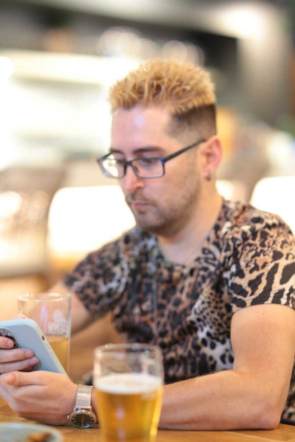 a man sitting at a table with a tablet