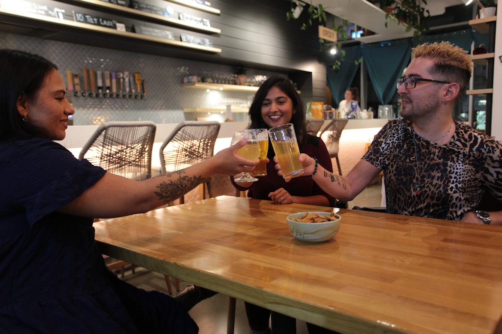 a group of people sitting around a wooden table