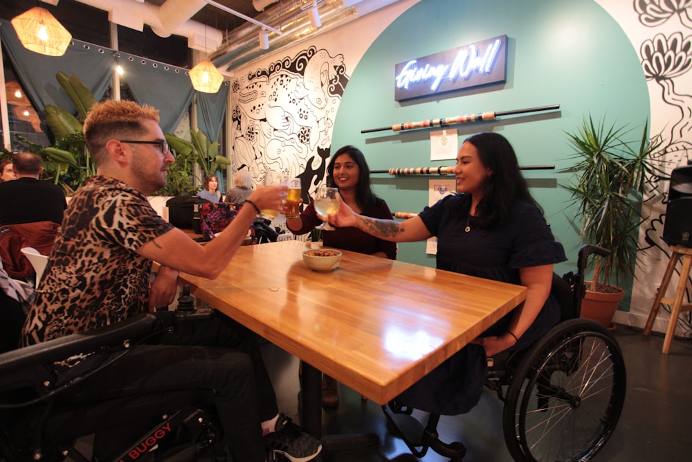 a man in a wheel chair holding a glass of wine