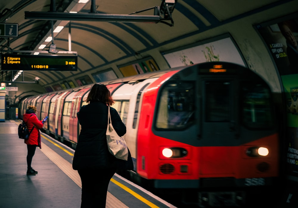 a red and white train pulling into a train station