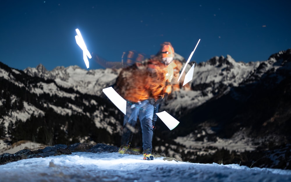 a man standing on top of a snow covered slope