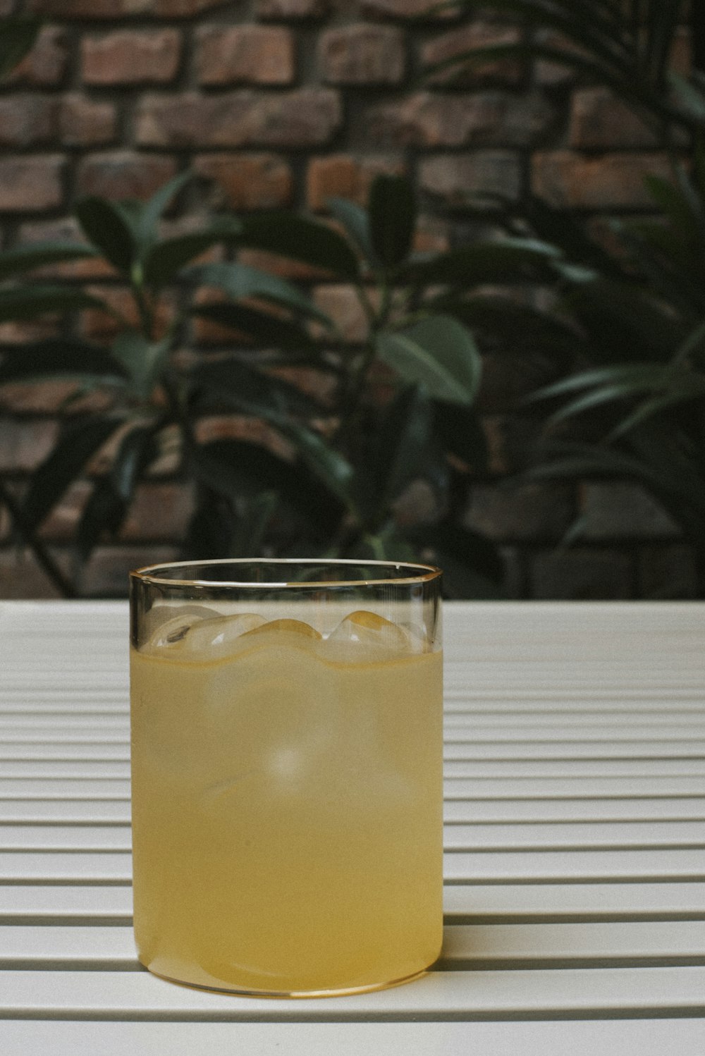 a glass filled with liquid sitting on top of a table