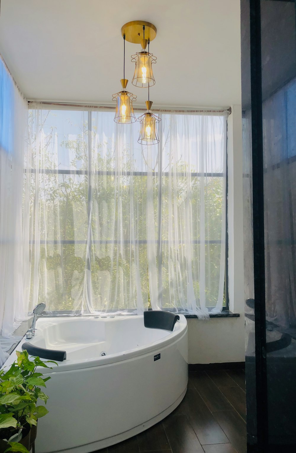 a bathroom with a round tub and a window