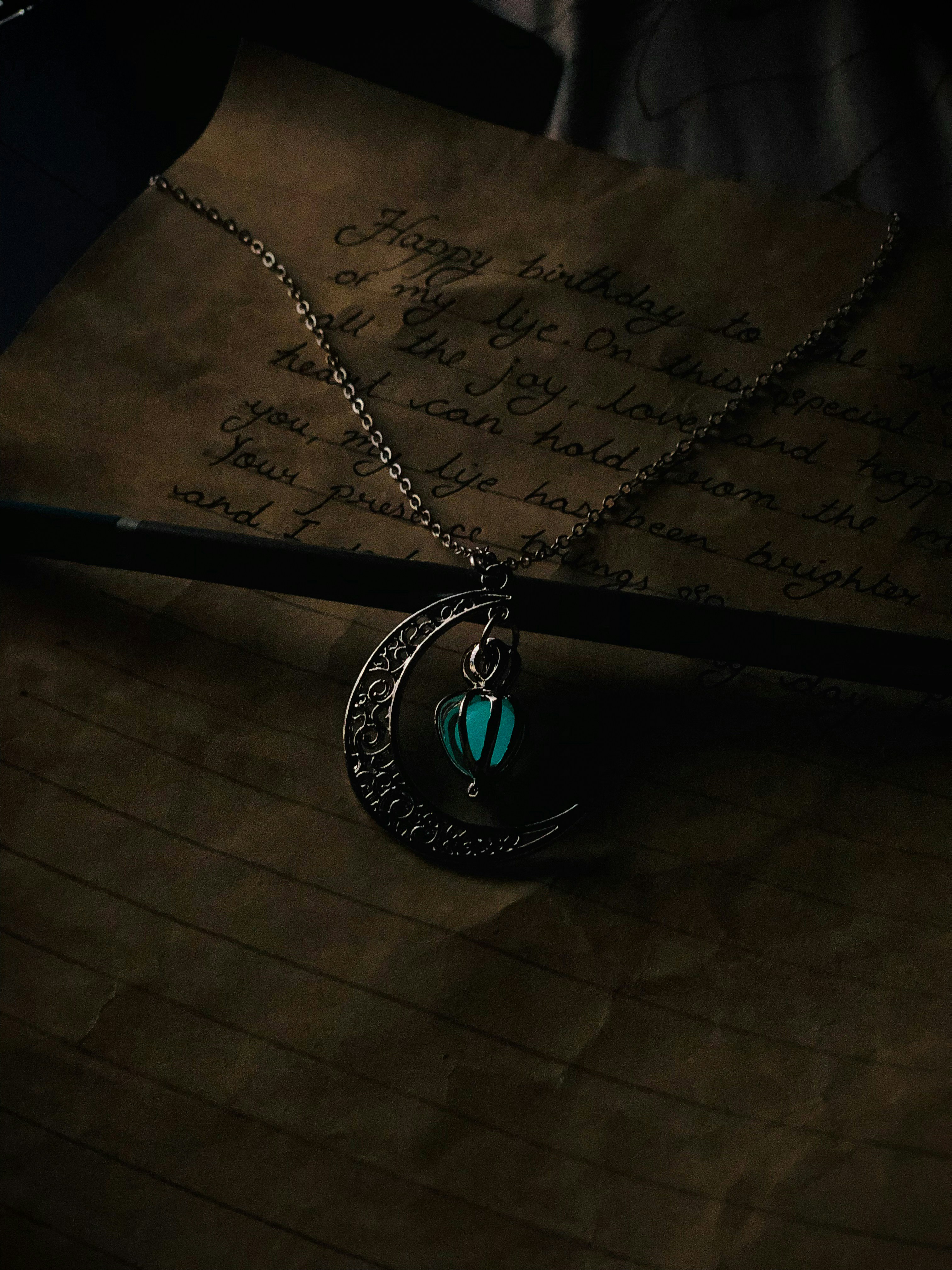 a close up of a necklace on a piece of paper