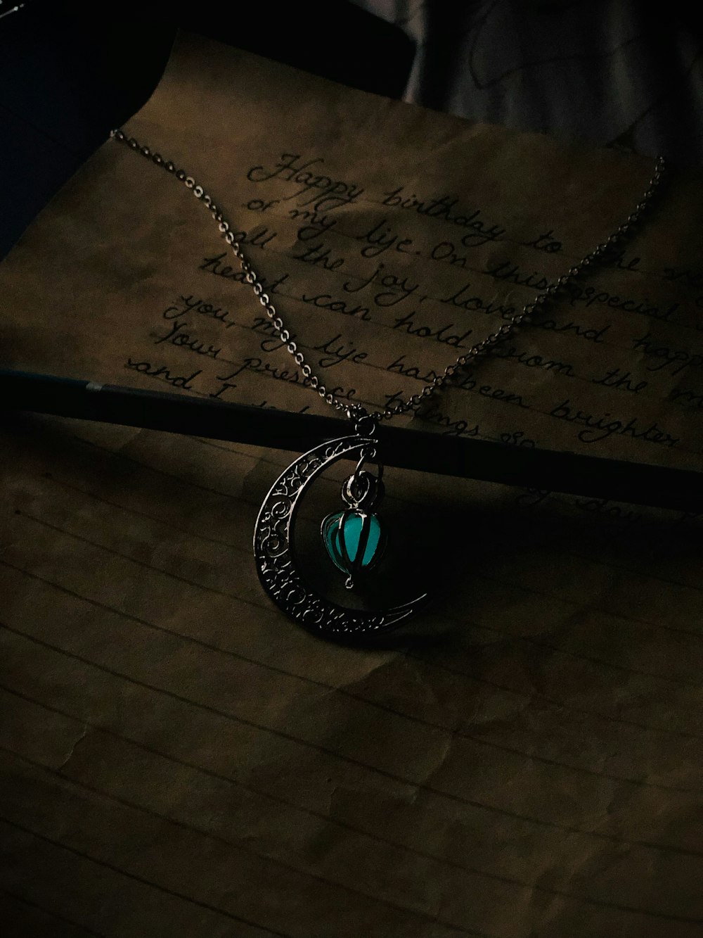 a close up of a necklace on a piece of paper