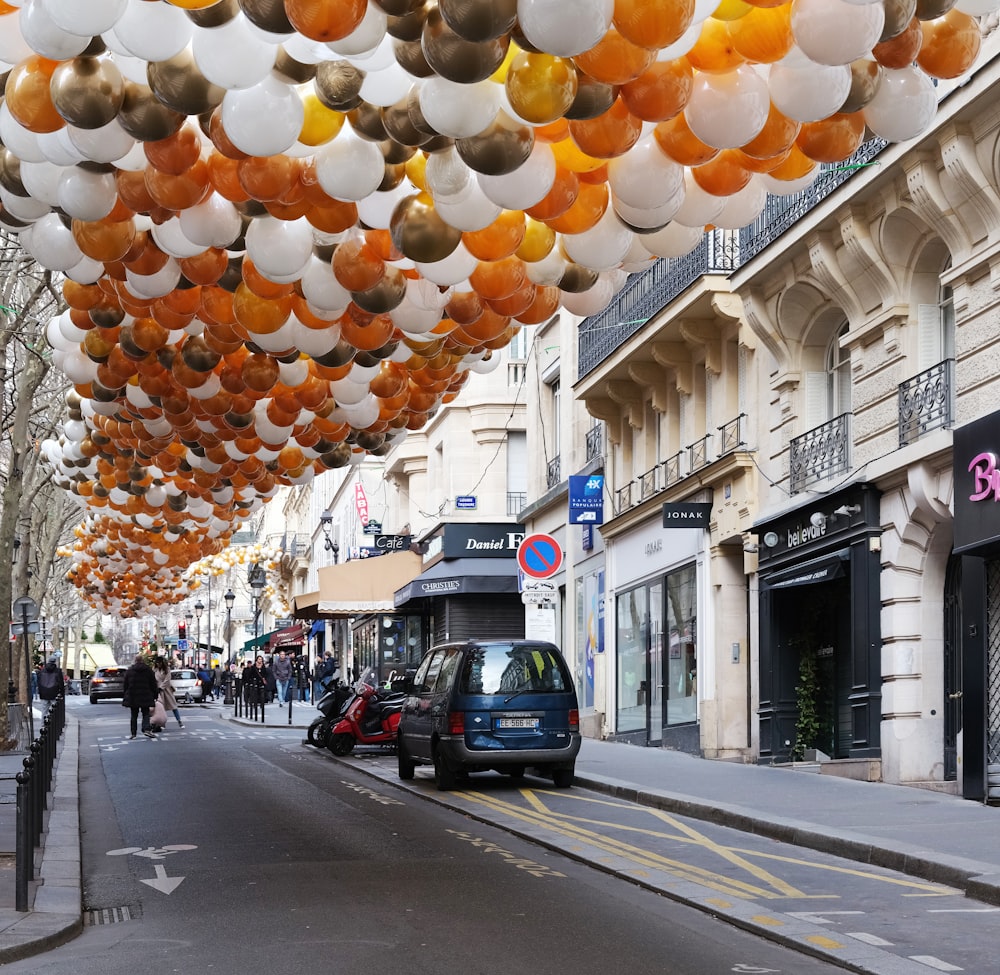 a street filled with lots of balloons hanging from the ceiling