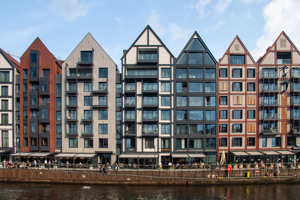 a row of buildings next to a body of water