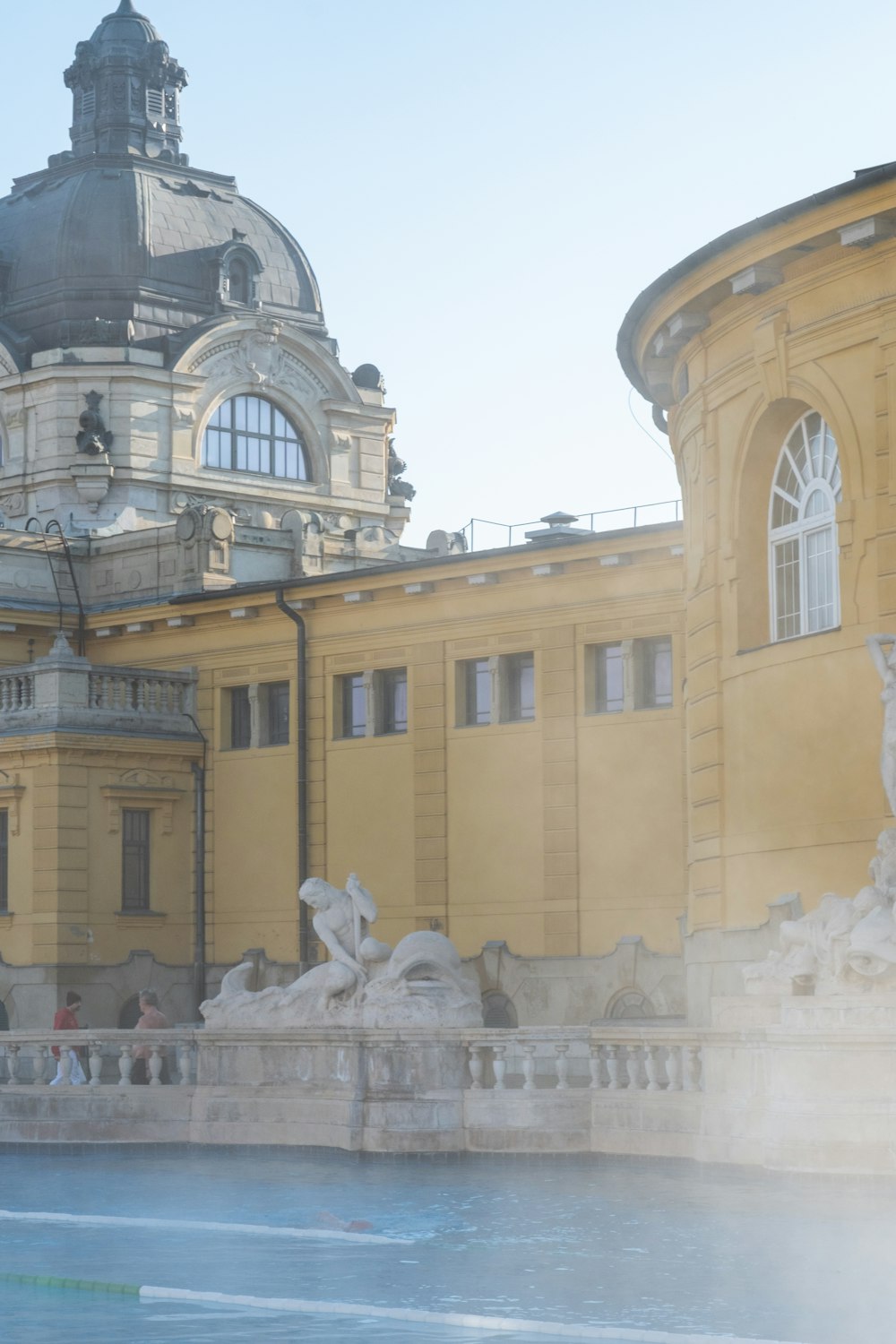 a large building with a fountain in front of it