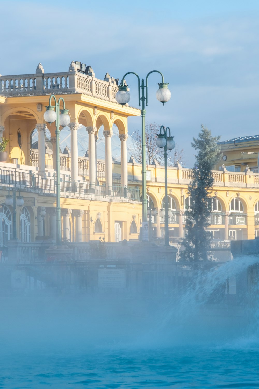 a large building with a fountain in front of it