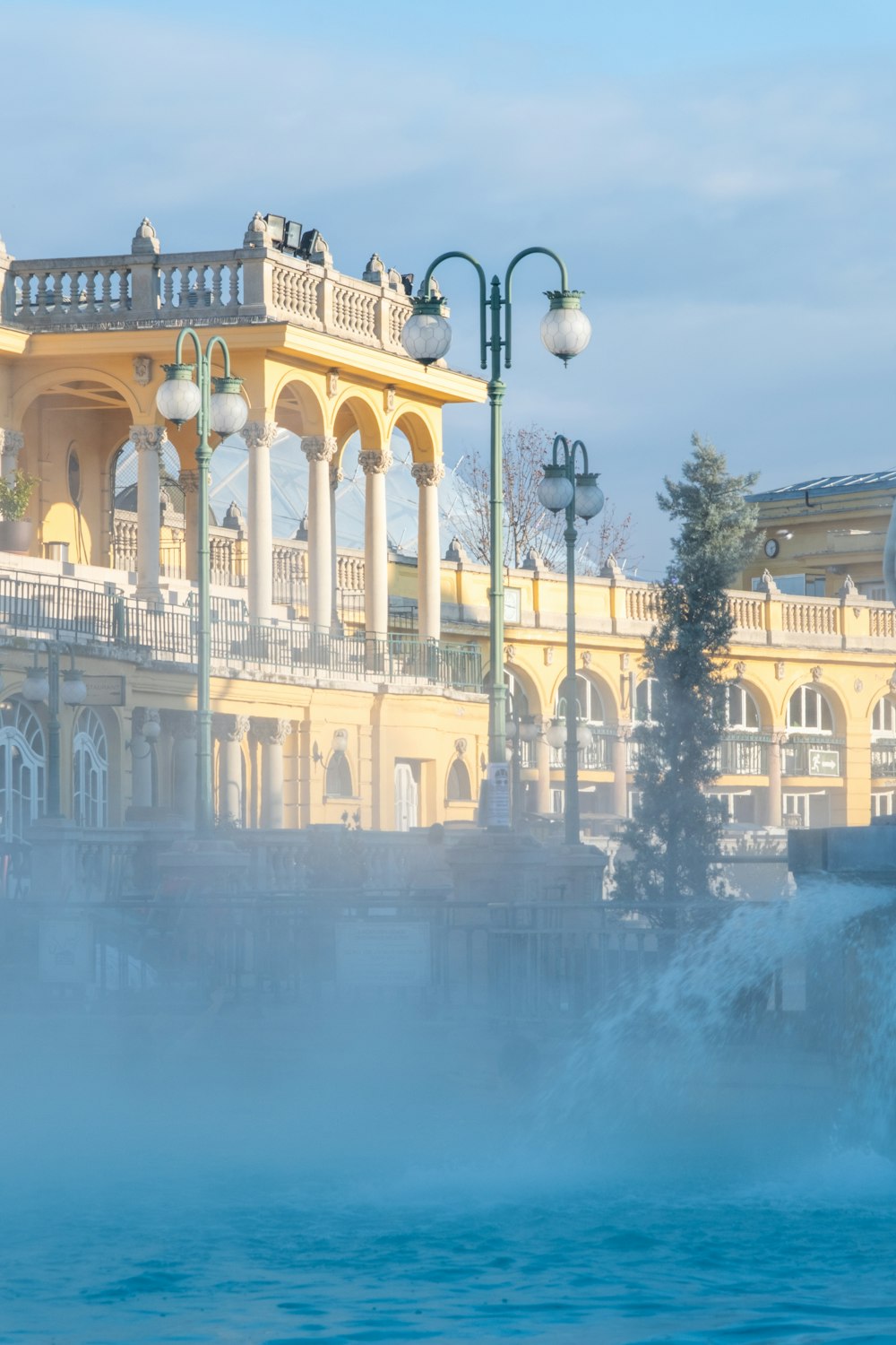 a large building with a fountain in front of it