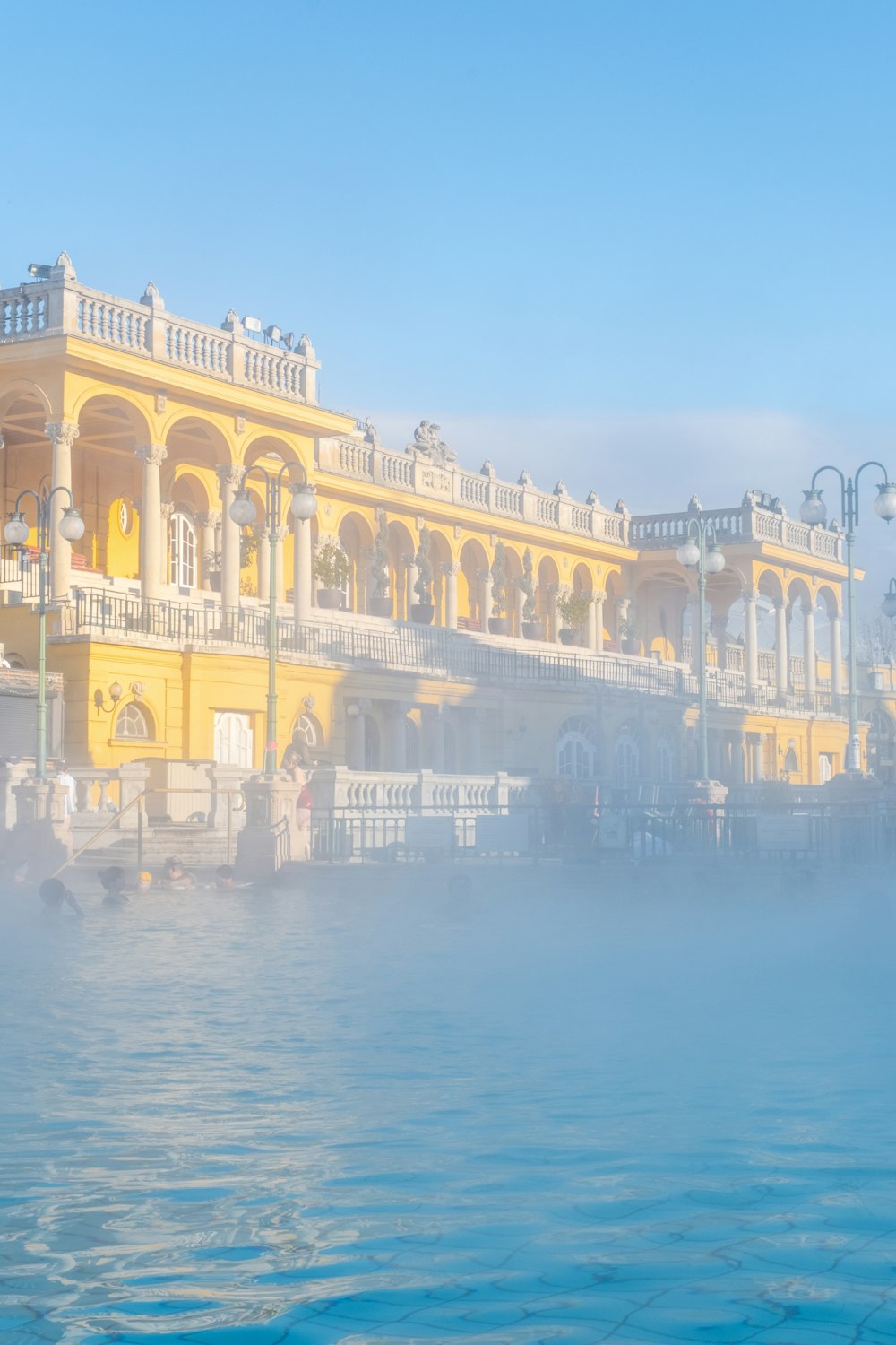 a large yellow building sitting next to a body of water