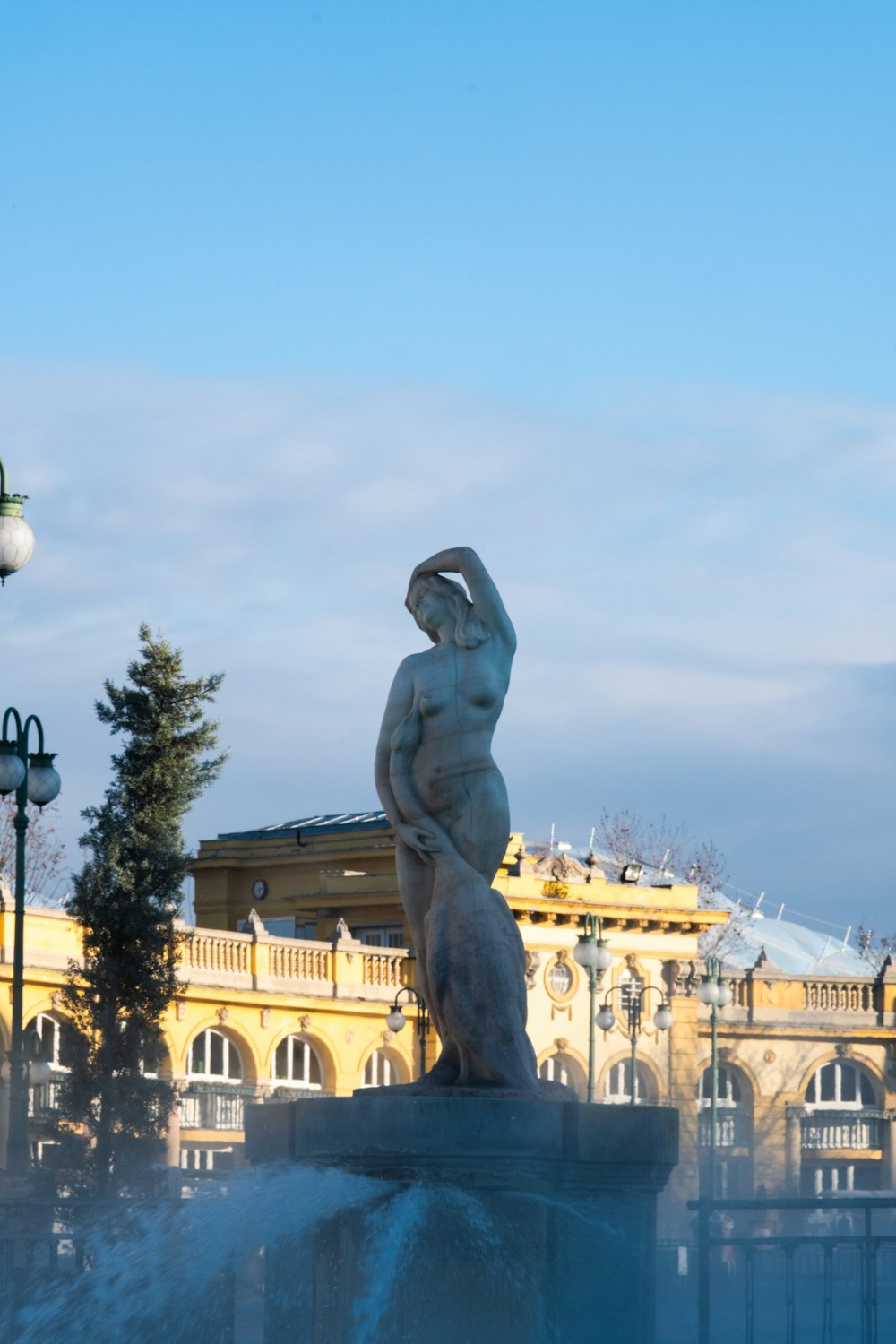 a statue of a woman in front of a building