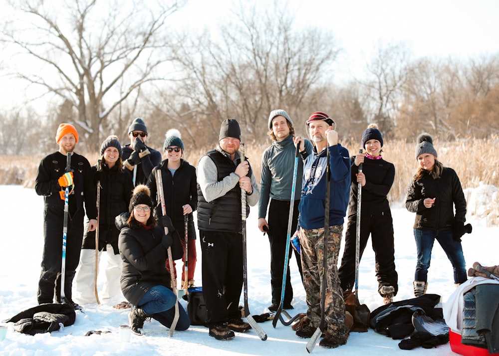 a group of people standing next to each other in the snow