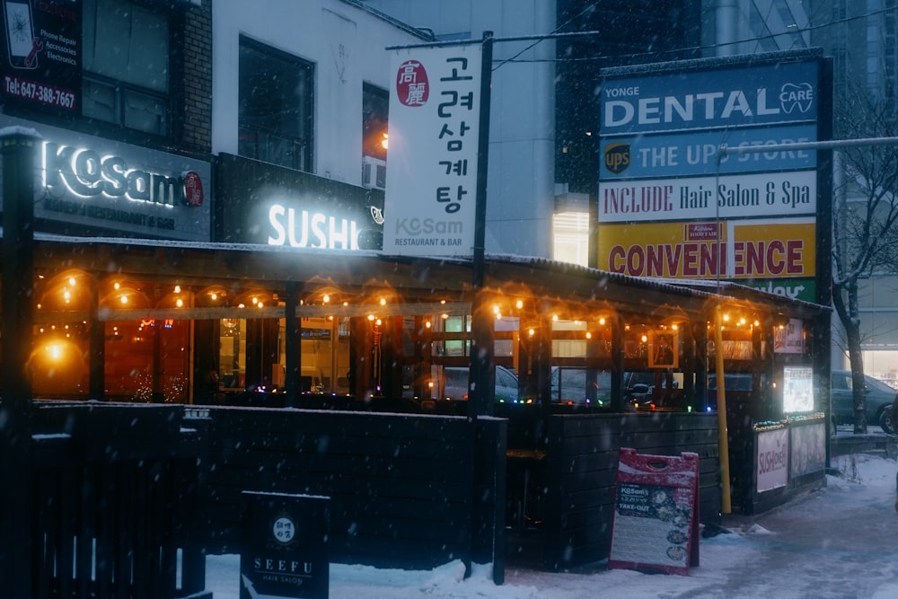 a small restaurant on a snowy street corner