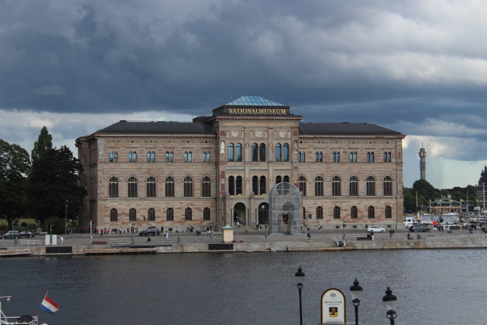 a large building sitting next to a body of water