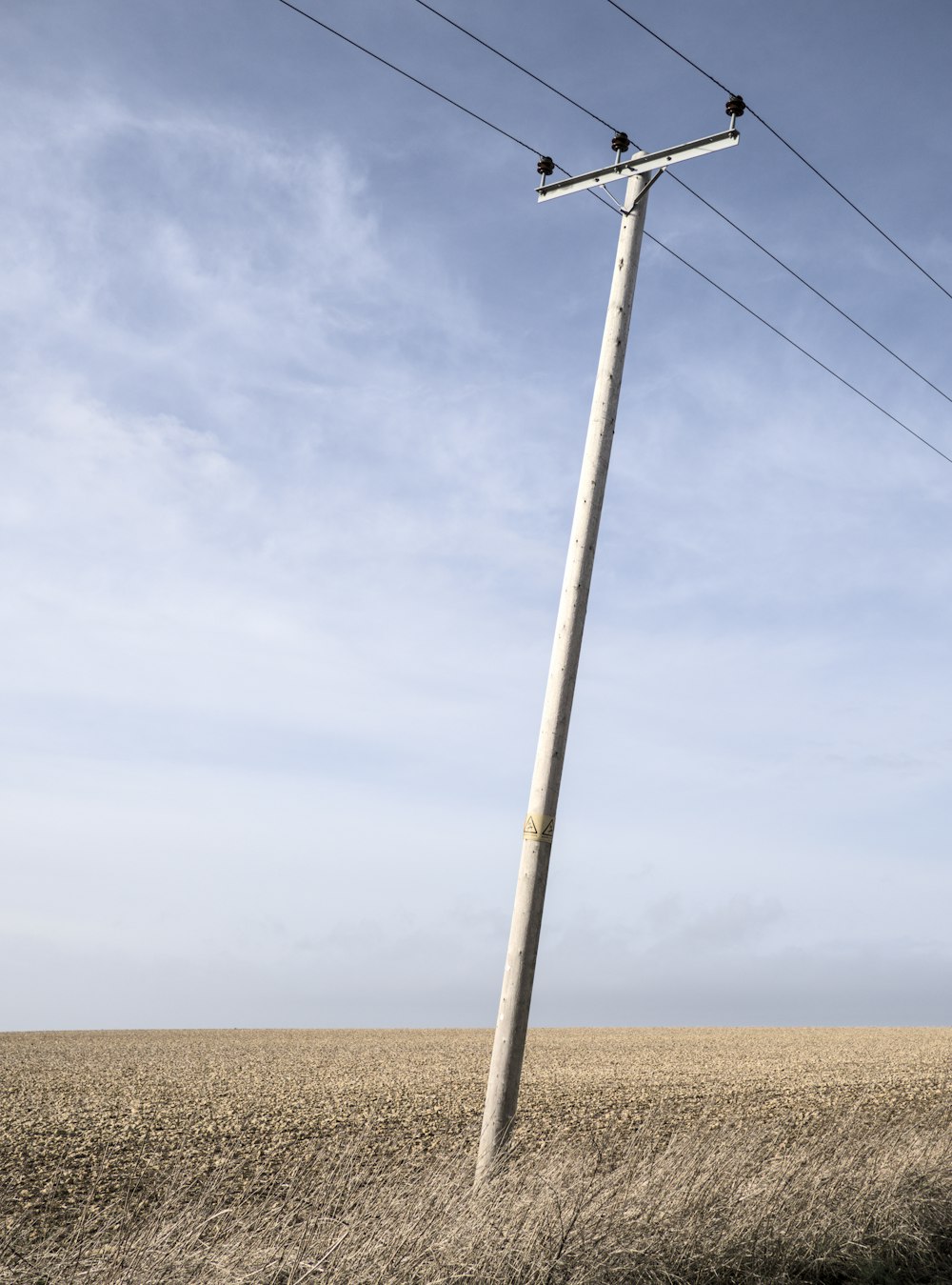 a telephone pole in the middle of a field