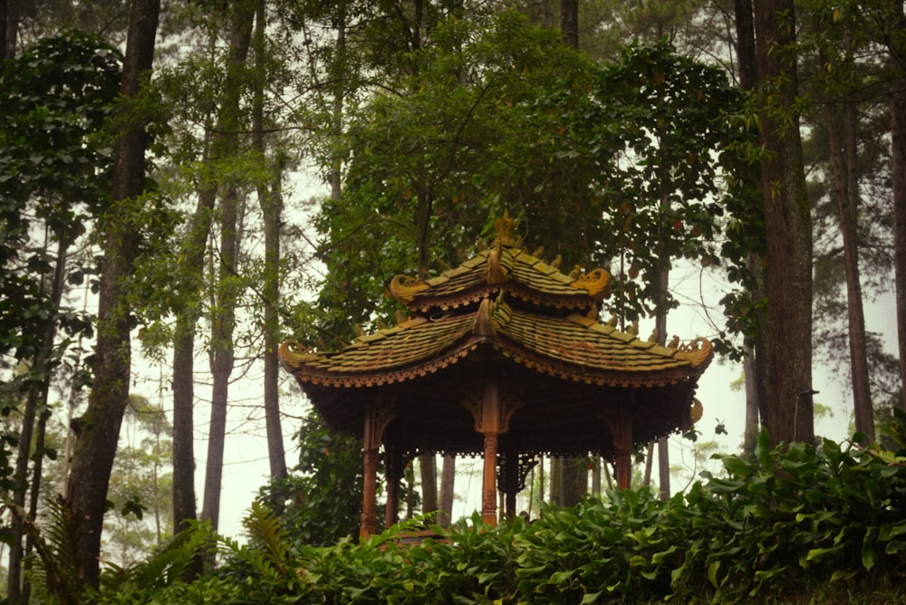 a gazebo in the middle of a forest