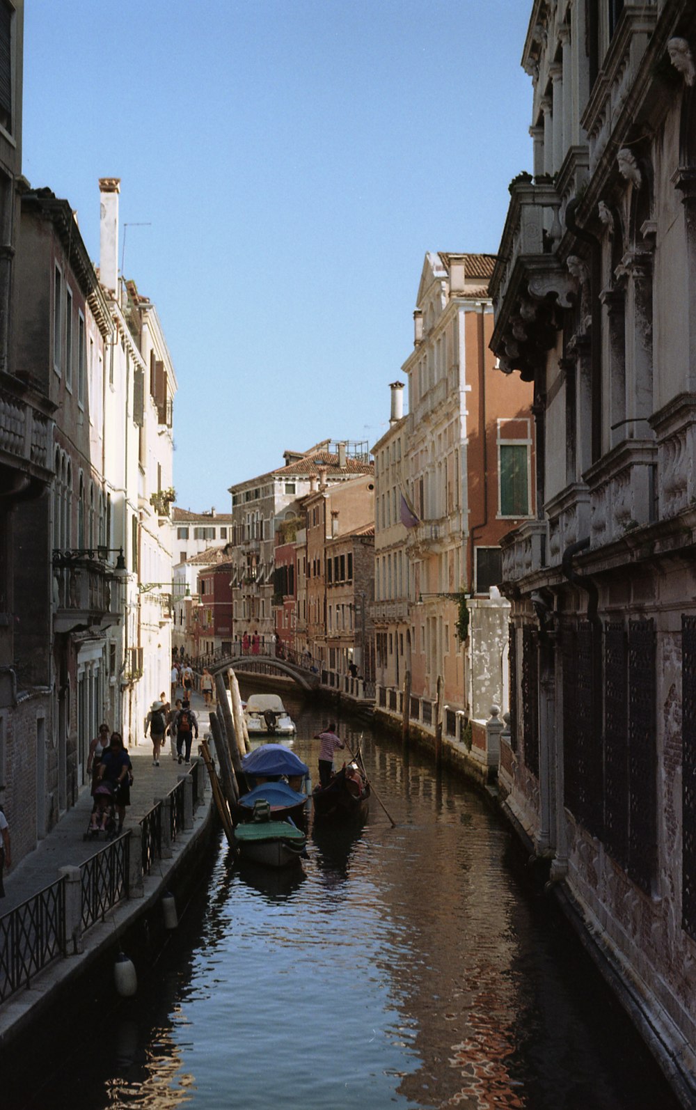 a narrow canal with several boats in it