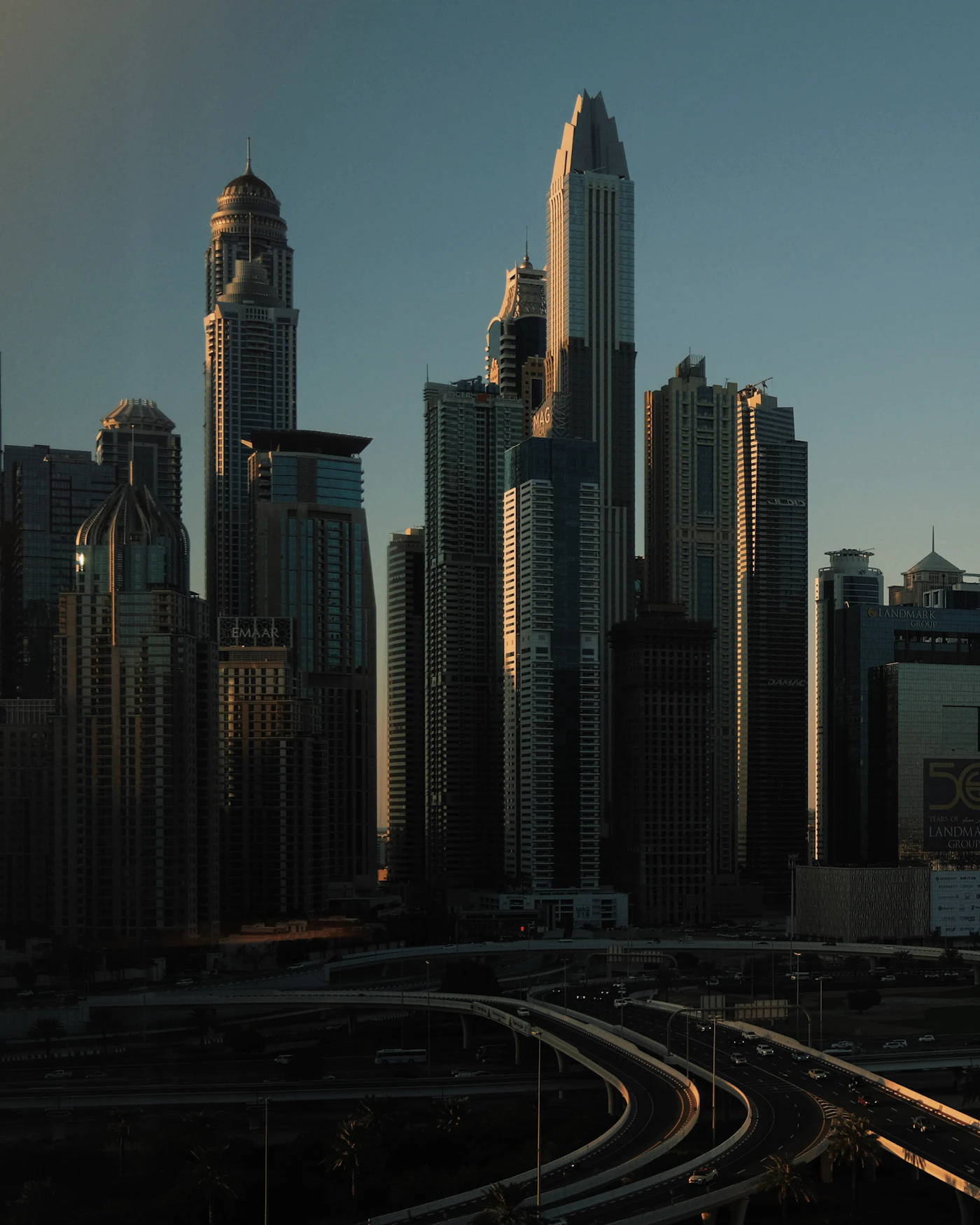Skyscrapers at dusk above a highway interchange