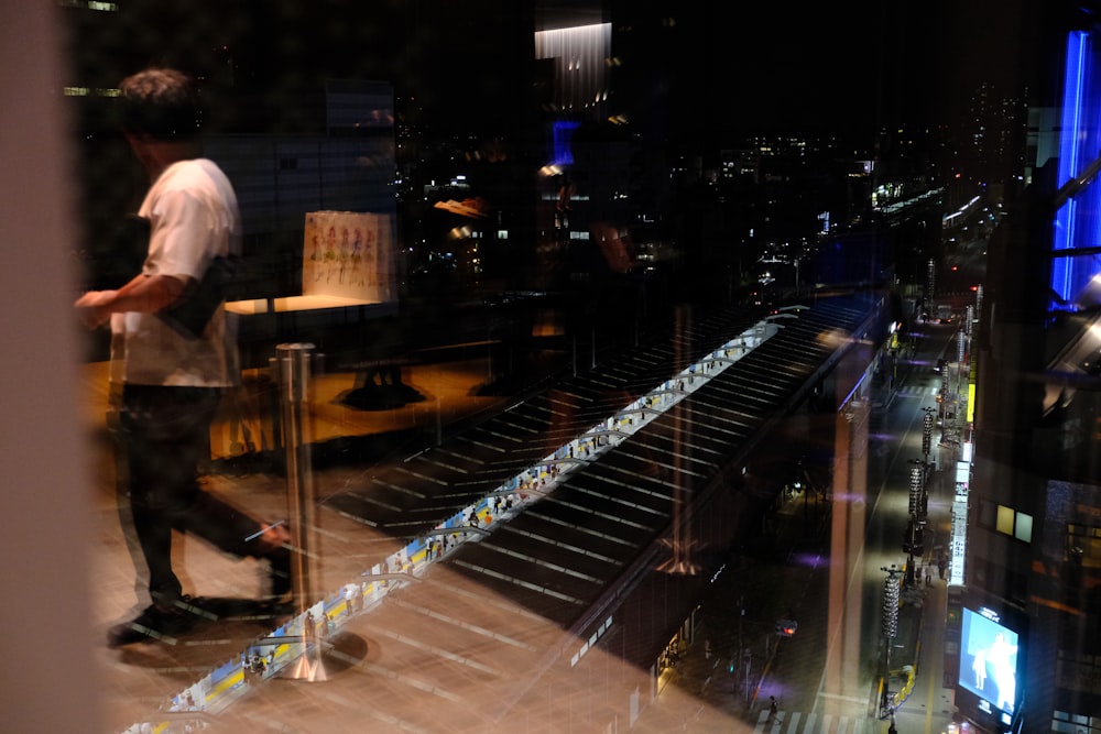 a man riding a skateboard next to a tall building