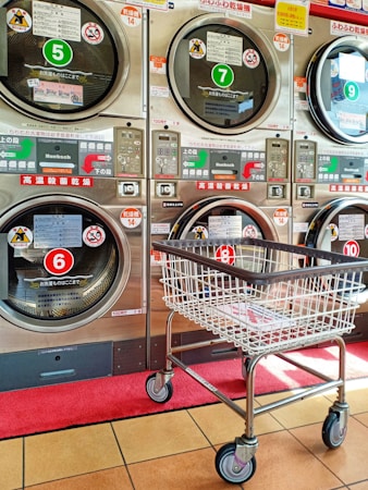 a shopping cart in front of a row of washers