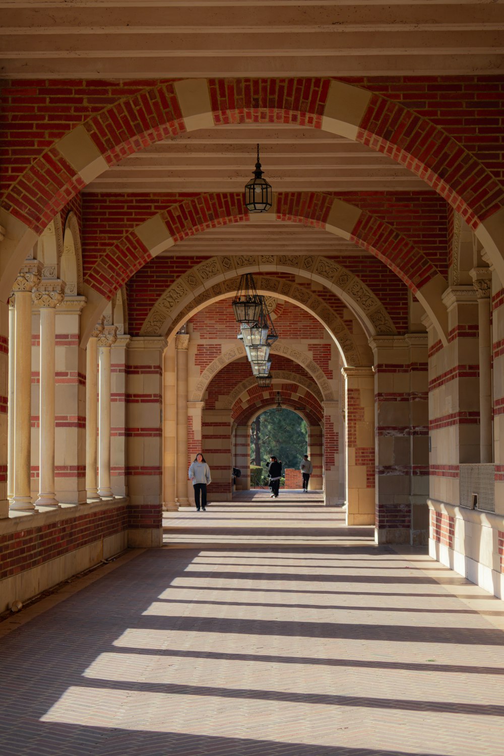 a person walking down a walkway under a light