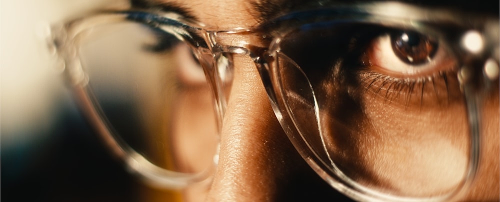 a close up of a person wearing glasses