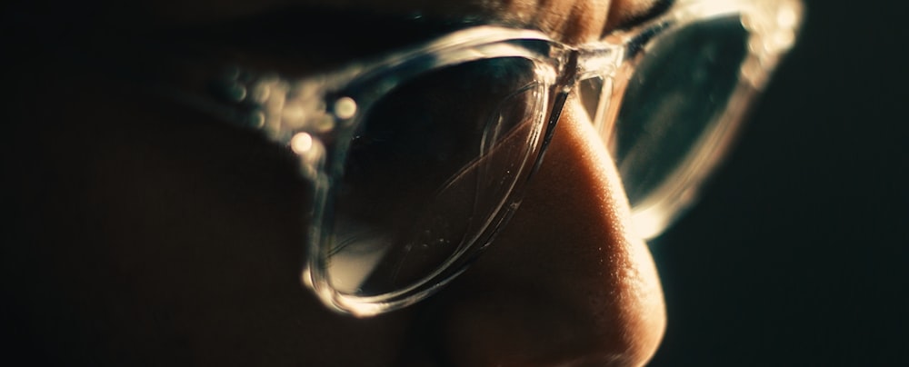 a close up of a person wearing glasses