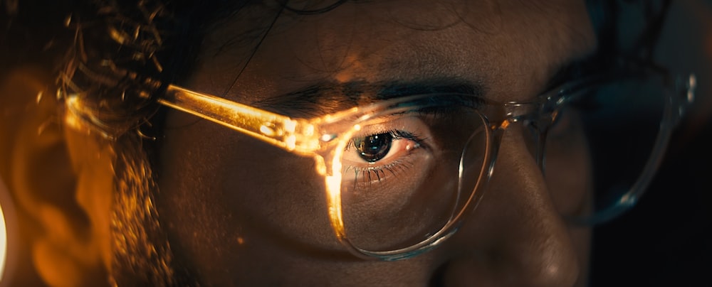 a close up of a person wearing glasses