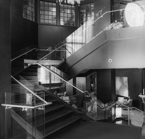 a black and white photo of a staircase in a building