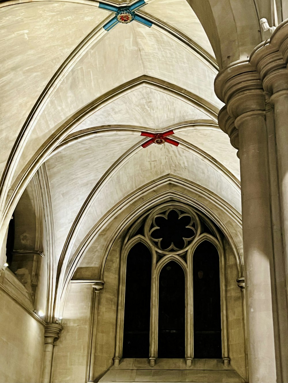 a large cathedral with a blue cross hanging from the ceiling