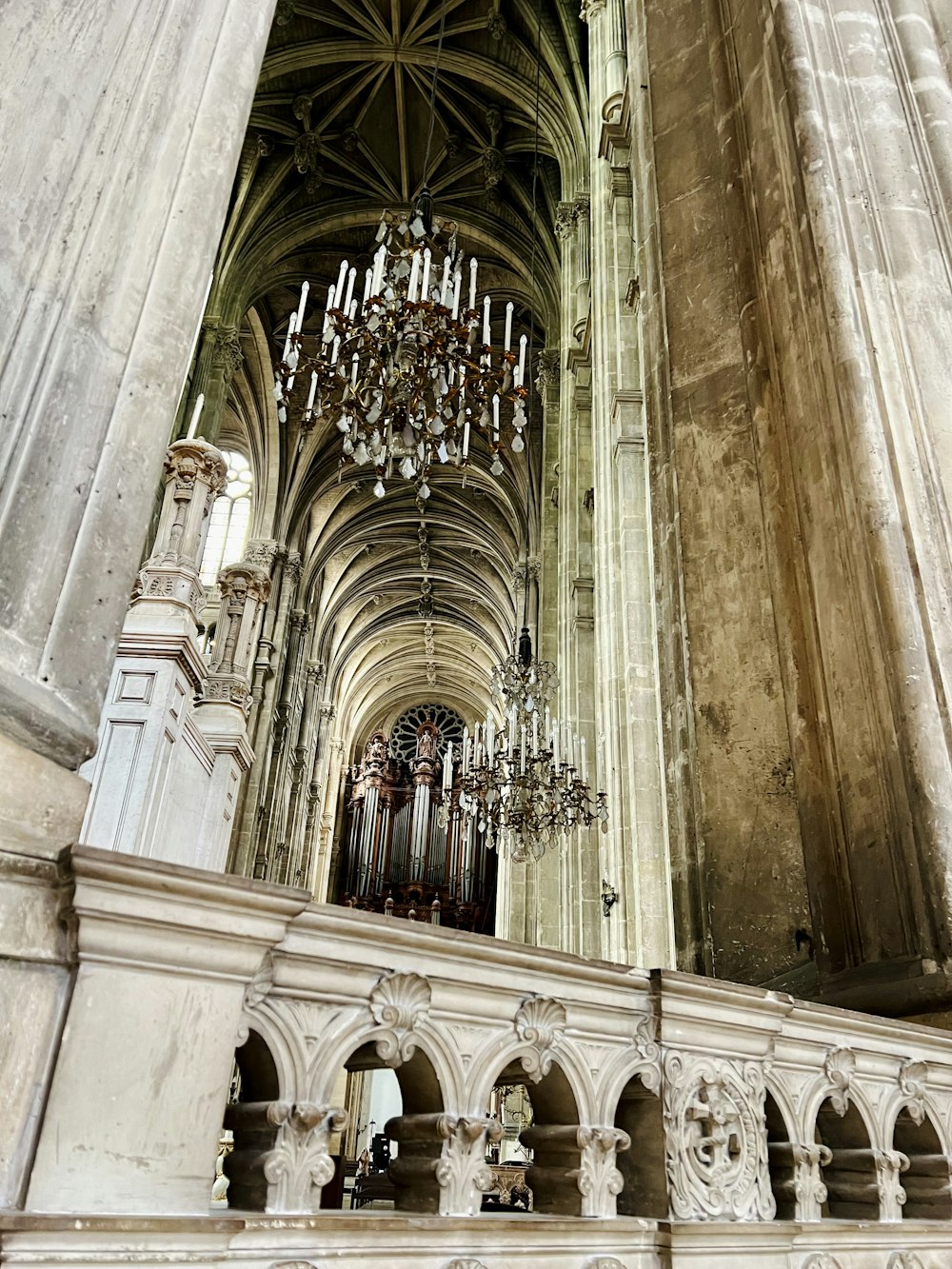 a chandelier hanging from the ceiling of a cathedral