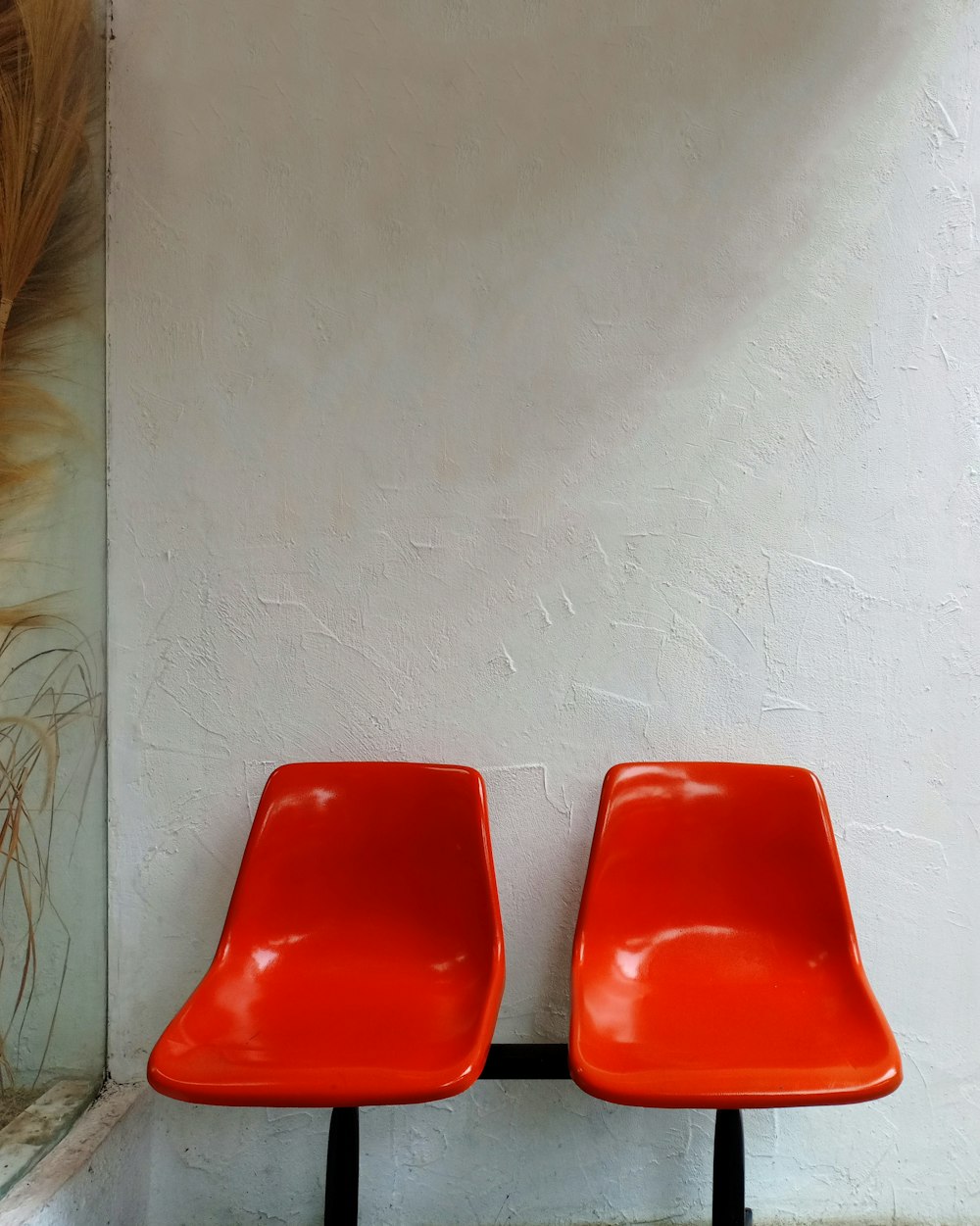 a couple of red chairs sitting next to each other