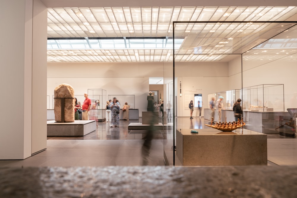 a group of people standing around a museum