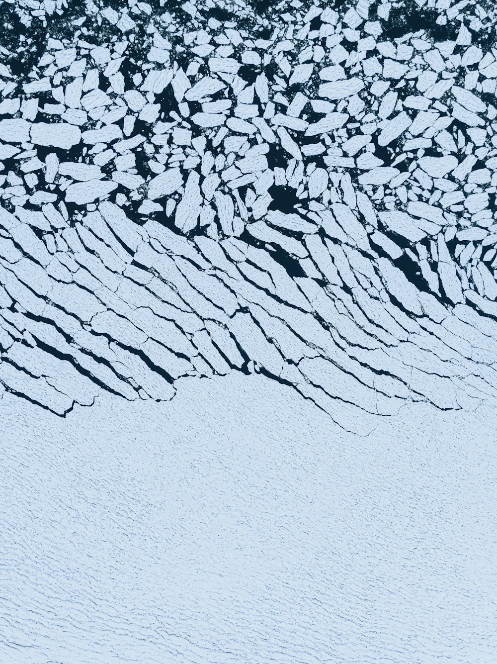 an aerial view of a snow covered mountain