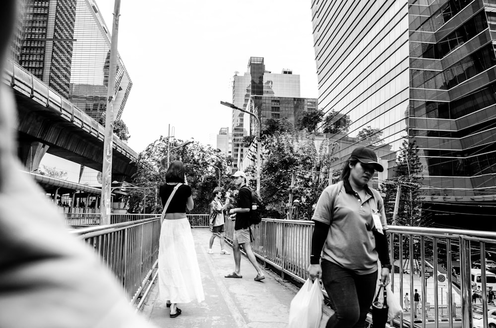 a group of people walking across a bridge