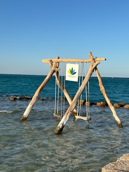 a wooden structure sitting in the middle of a body of water