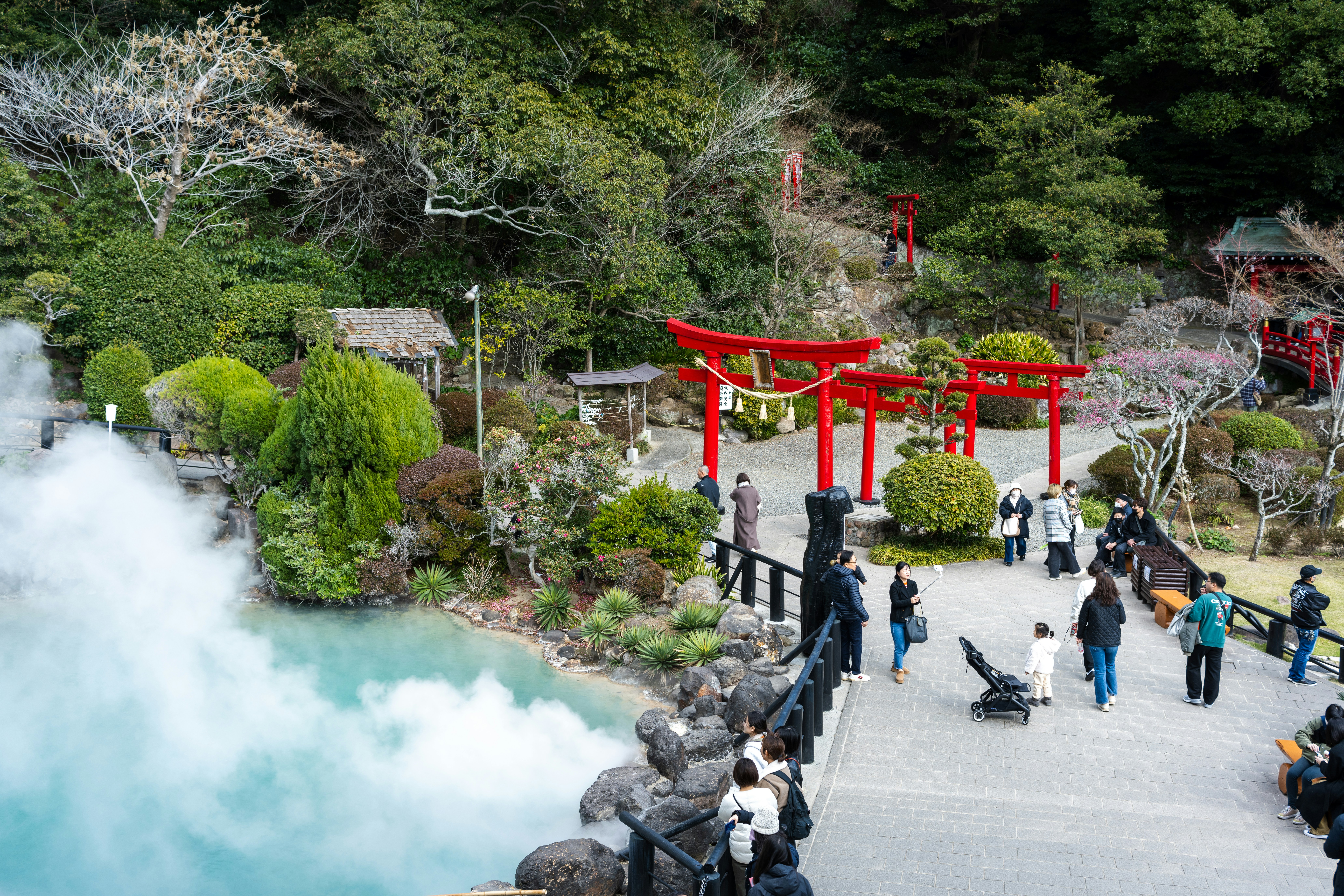 a group of people standing around a body of water