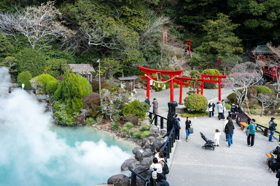 a group of people standing around a body of water