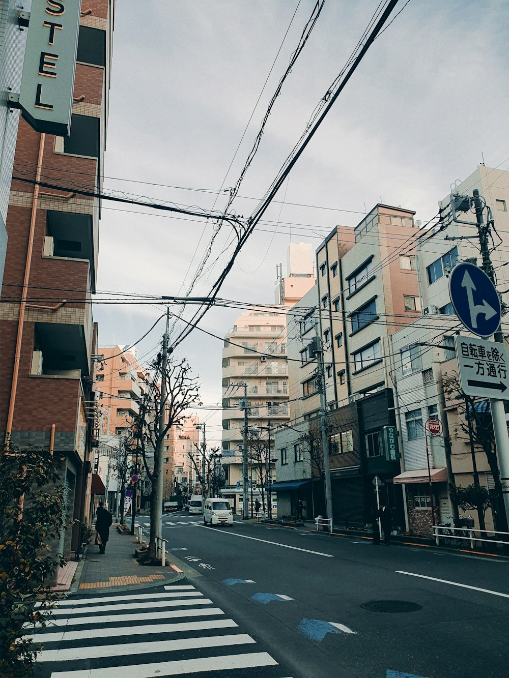 a city street with buildings and a crosswalk