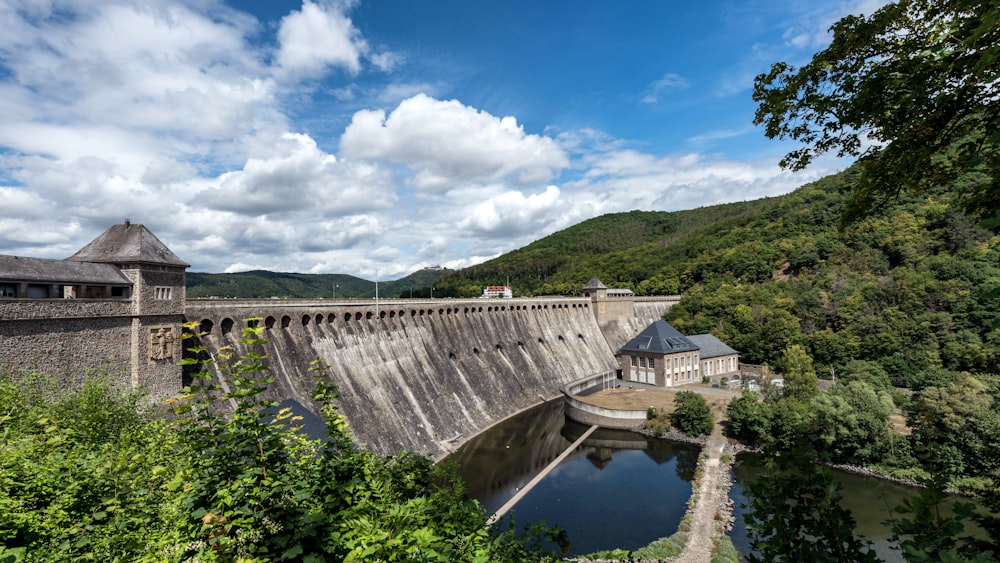 a dam in the middle of a river surrounded by trees