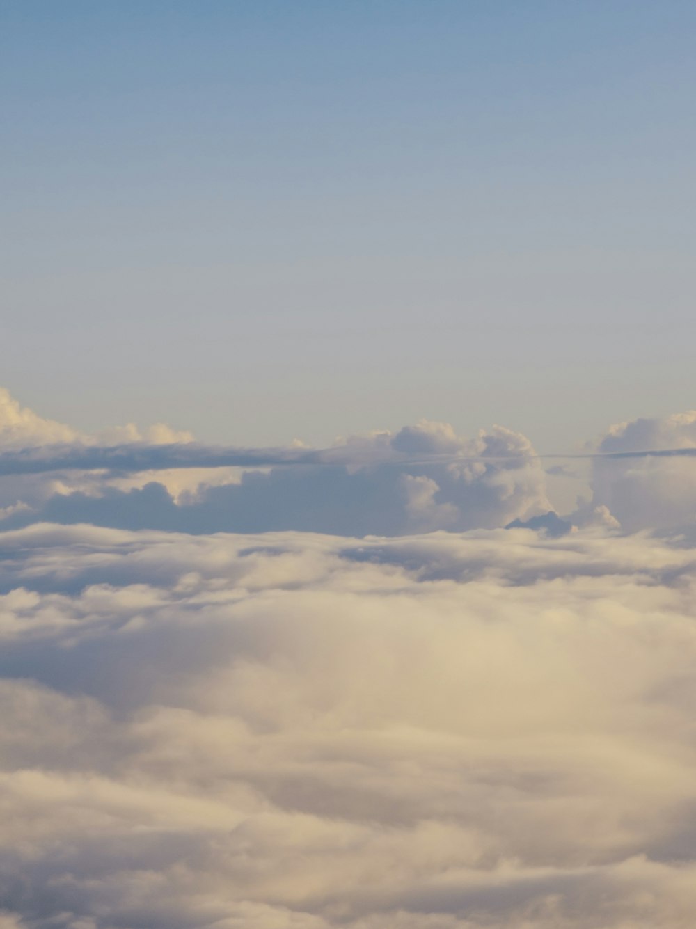 an airplane is flying high above the clouds