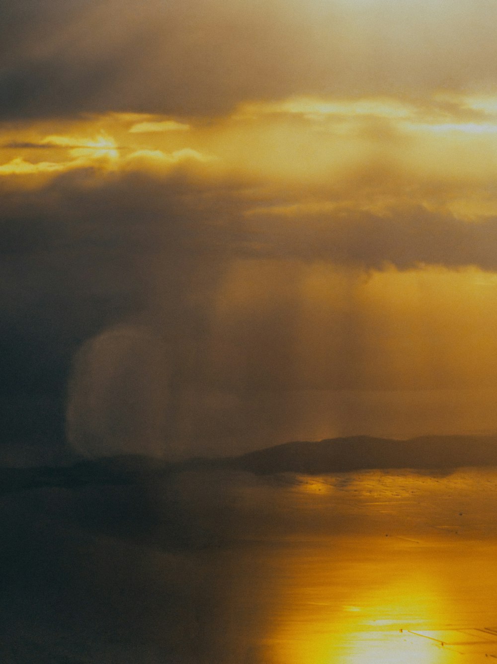 a plane flying in the sky over a body of water